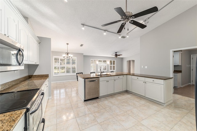 kitchen featuring stainless steel appliances, kitchen peninsula, and white cabinets