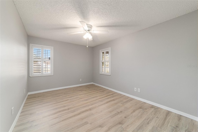 unfurnished room featuring ceiling fan, a textured ceiling, and light wood-type flooring