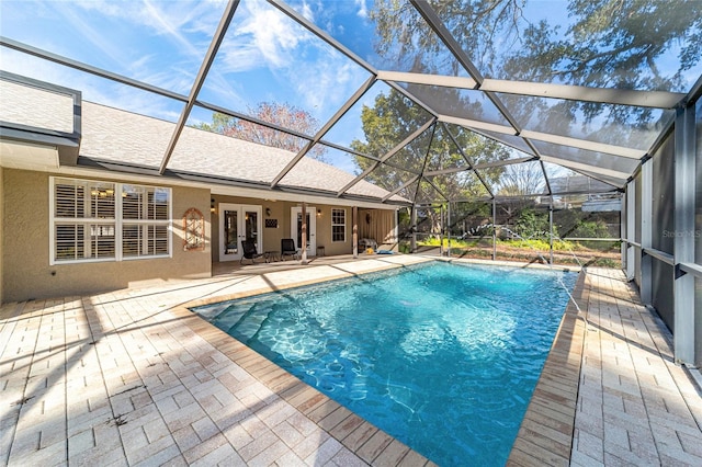 view of swimming pool featuring a lanai and a patio area