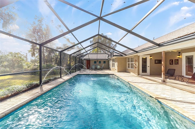 view of pool with pool water feature, a lanai, and a patio area