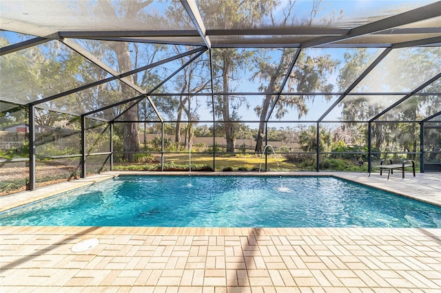 view of swimming pool featuring a lanai and a patio area