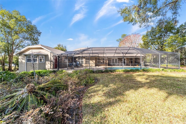 rear view of property featuring glass enclosure and a lawn