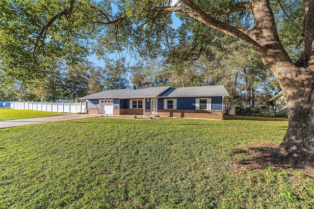 ranch-style house with brick siding, an attached garage, fence, driveway, and a front lawn