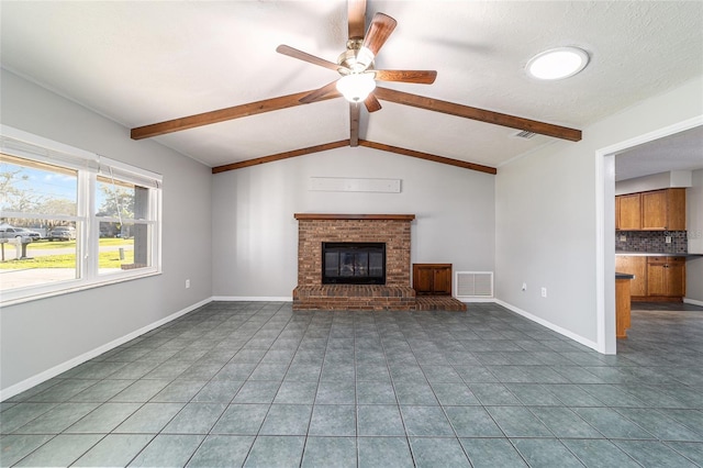 unfurnished living room featuring vaulted ceiling with beams, a fireplace, visible vents, tile patterned flooring, and baseboards