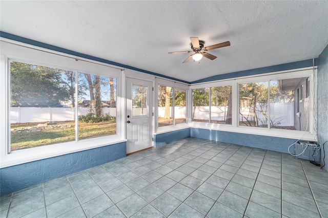 unfurnished sunroom featuring a ceiling fan