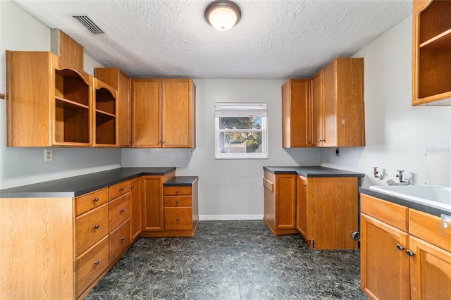 kitchen with brown cabinets, visible vents, and open shelves