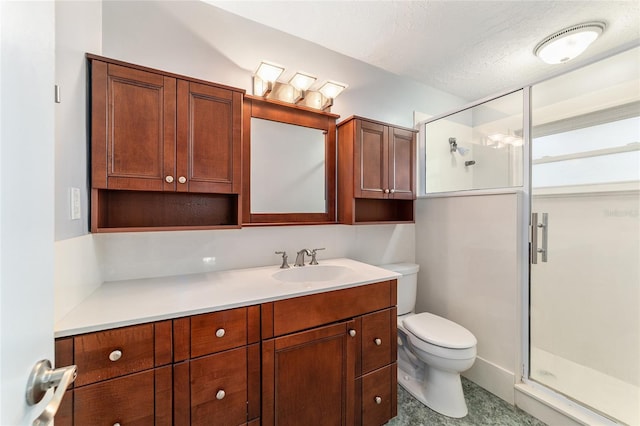 bathroom with a textured ceiling, a stall shower, vanity, and toilet