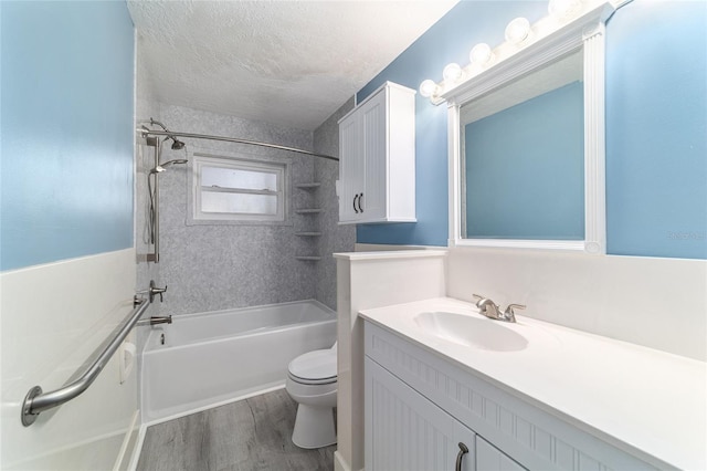 full bathroom with toilet, wood finished floors,  shower combination, a textured ceiling, and vanity