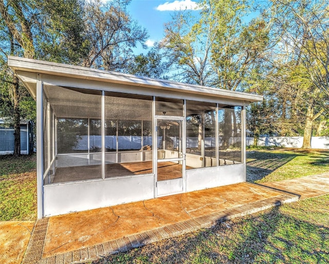 exterior space with a sunroom and fence