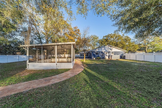 view of yard with a sunroom and fence