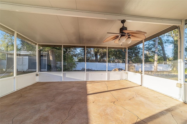 unfurnished sunroom featuring a ceiling fan