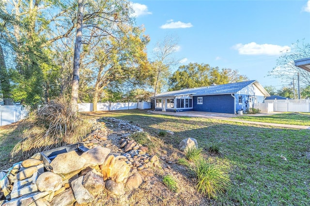 view of front of property with a front yard and a fenced backyard