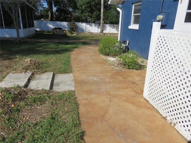 view of yard with a sunroom and fence