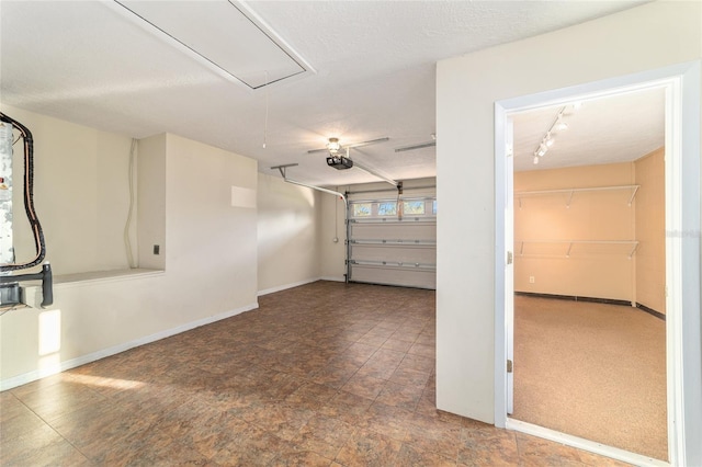 garage with a garage door opener and baseboards