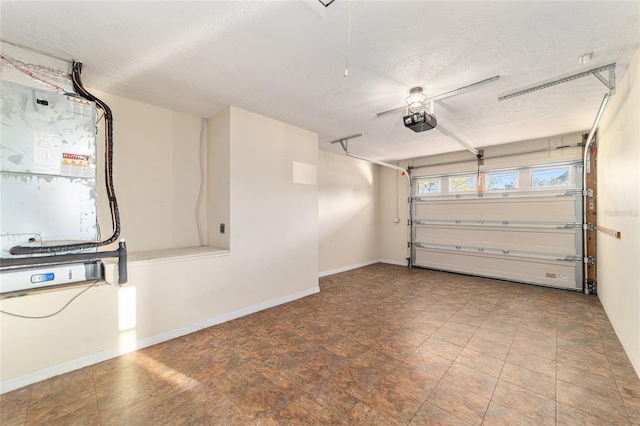 garage with baseboards and a garage door opener