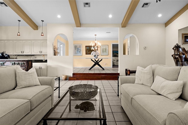 living room with light tile patterned floors, beamed ceiling, visible vents, and a notable chandelier