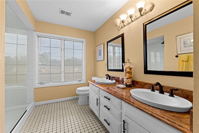 full bathroom featuring visible vents, a sink, toilet, and a walk in shower