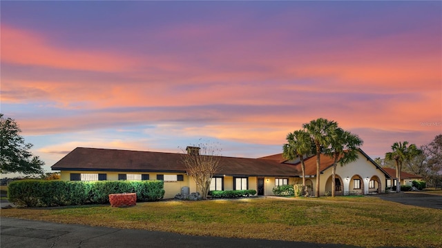 ranch-style house featuring a yard