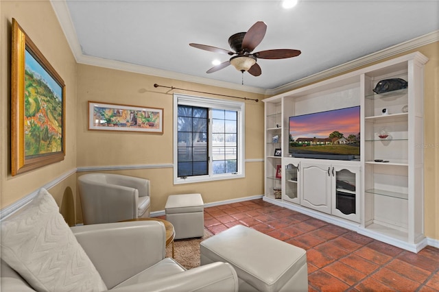 living area featuring ornamental molding, dark tile patterned floors, a ceiling fan, and baseboards