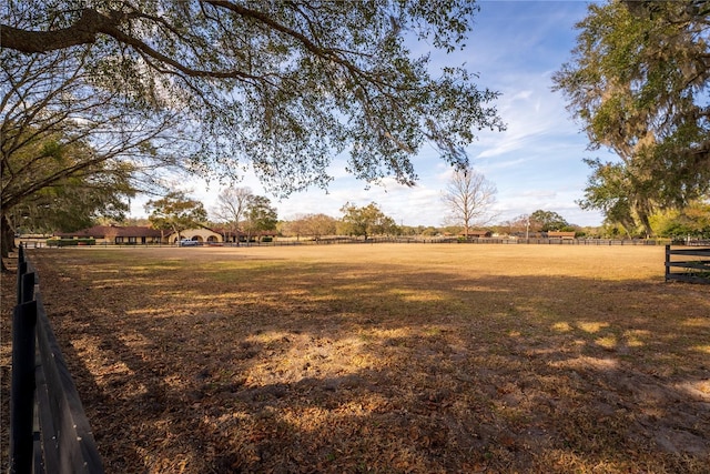 view of yard featuring a rural view and fence