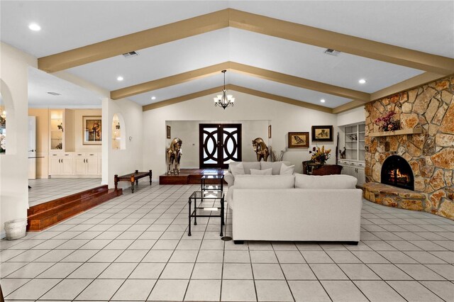 living area with light tile patterned floors, a fireplace, visible vents, and a notable chandelier