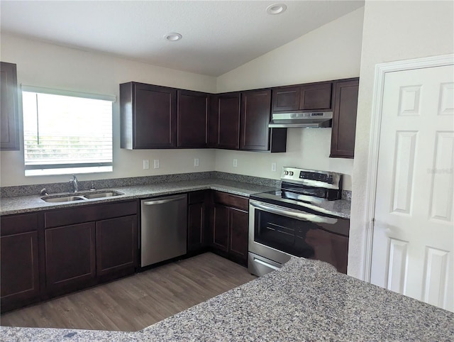 kitchen with lofted ceiling, dark brown cabinetry, sink, appliances with stainless steel finishes, and dark hardwood / wood-style flooring