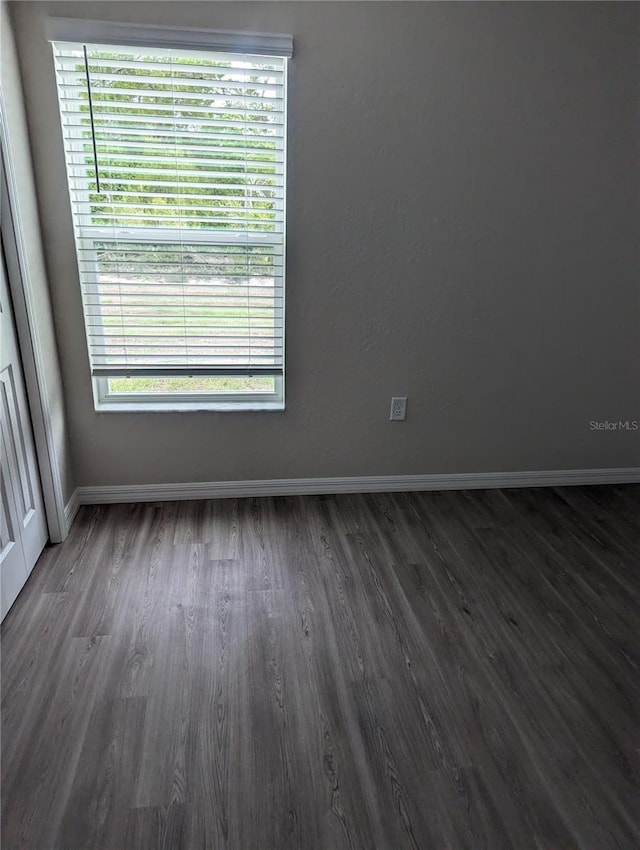 unfurnished room with dark hardwood / wood-style floors