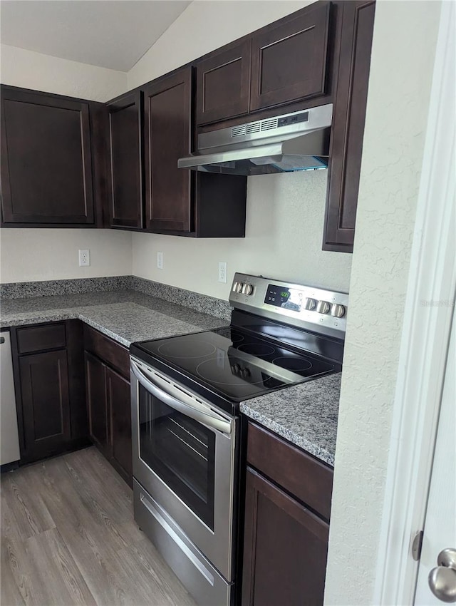 kitchen featuring lofted ceiling, light wood-type flooring, dark brown cabinets, and electric range