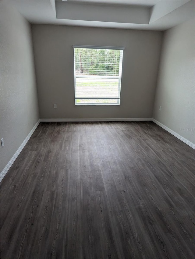 unfurnished room featuring dark hardwood / wood-style flooring