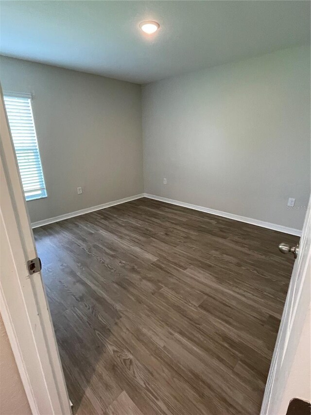 2792 SW 161st Loop, Ocala, FL 34473 - empty room featuring dark wood-type flooring, baseboards, and recessed lighting