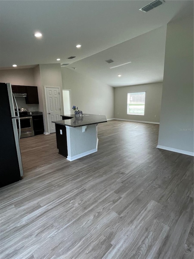 2792 SW 161st Loop, Ocala, FL 34473 - kitchen with stainless steel appliances, open floor plan, wood finished floors, baseboards, and dark countertops