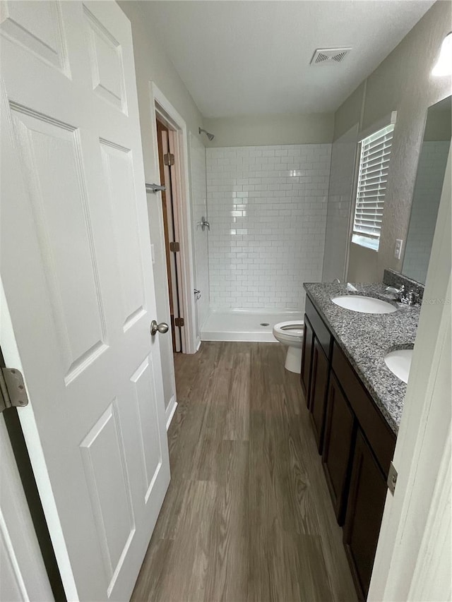 2792 SW 161st Loop, Ocala, FL 34473 - full bath featuring a stall shower, wood finished floors, double vanity, and toilet