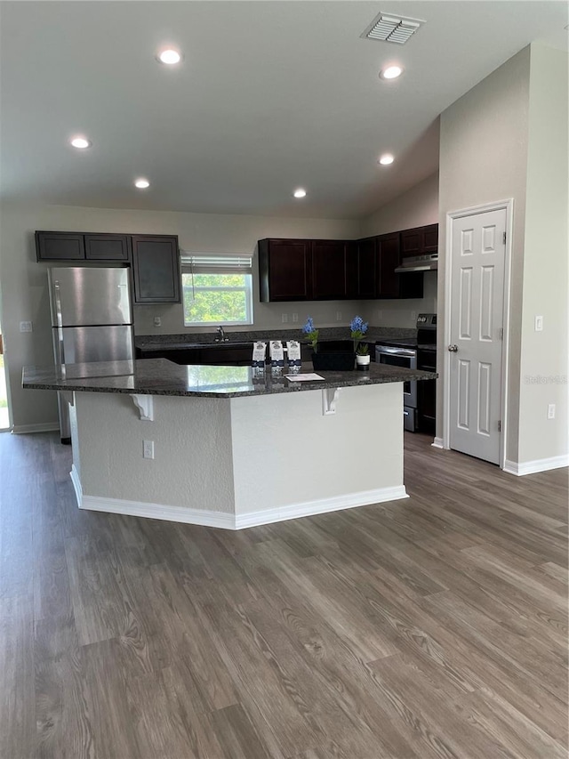 2792 SW 161st Loop, Ocala, FL 34473 - kitchen featuring stainless steel appliances, dark wood finished floors, dark stone countertops, under cabinet range hood, and recessed lighting
