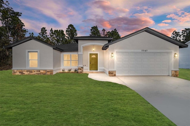 view of front of home featuring a garage and a yard