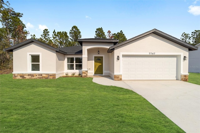 view of front of home featuring a garage and a front lawn