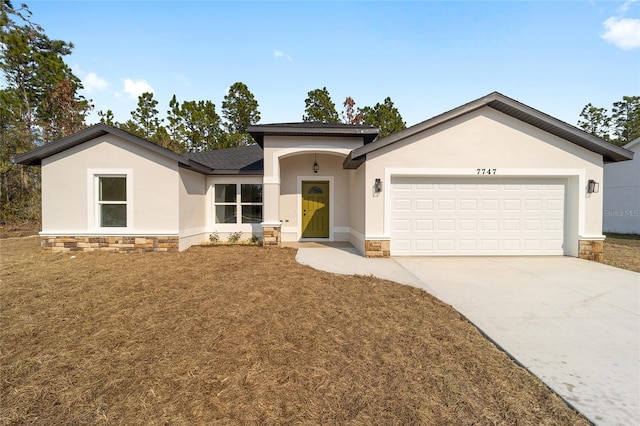 view of front facade featuring a garage and a front lawn