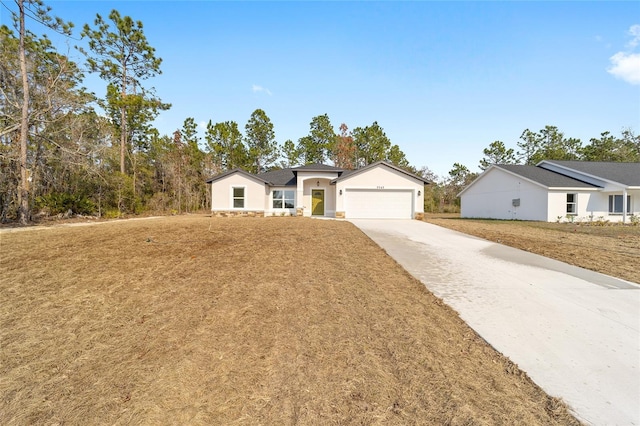 view of front facade with a garage and a front lawn