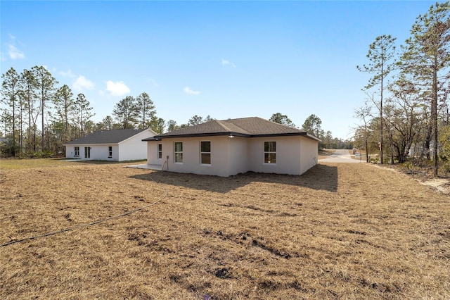 rear view of property featuring a yard