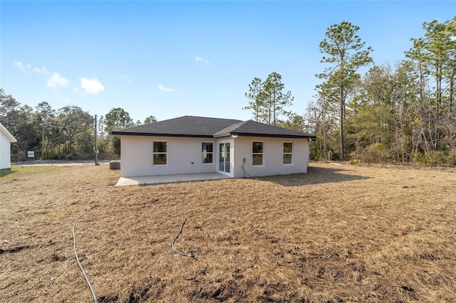 view of front of house featuring a front lawn and a patio area