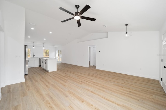 unfurnished living room with ceiling fan, vaulted ceiling, and light hardwood / wood-style flooring