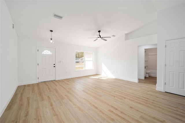 foyer entrance with ceiling fan, vaulted ceiling, and light hardwood / wood-style flooring