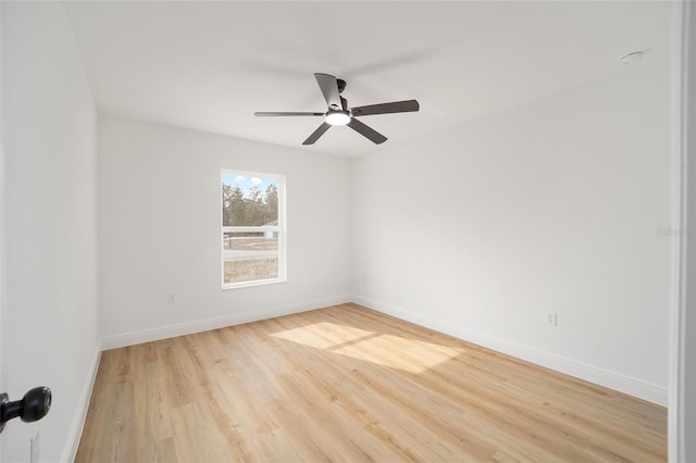 empty room featuring ceiling fan and hardwood / wood-style floors