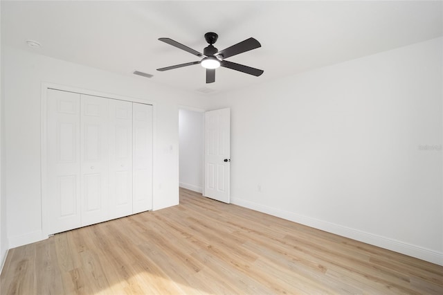 unfurnished bedroom featuring a closet, ceiling fan, and light wood-type flooring