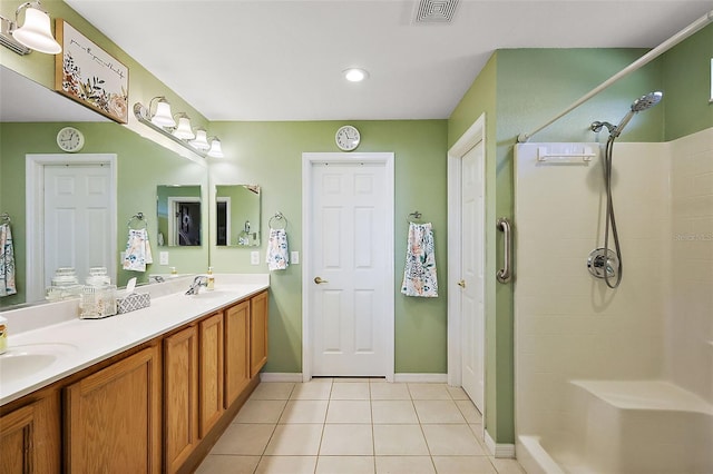 bathroom with vanity, tile patterned floors, and walk in shower