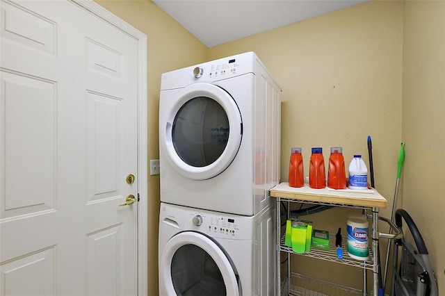 washroom with stacked washing maching and dryer