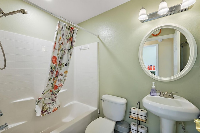 full bathroom with sink, toilet, and shower / bath combo with shower curtain