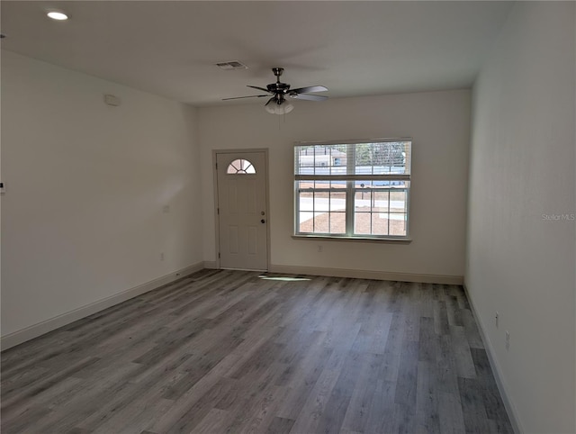 foyer with hardwood / wood-style flooring and ceiling fan