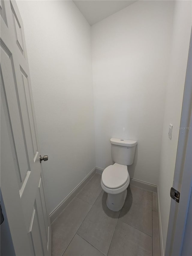 bathroom with tile patterned flooring and toilet