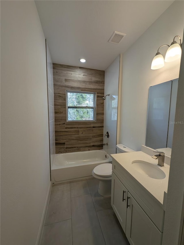 full bathroom with tiled shower / bath combo, vanity, tile patterned floors, and toilet