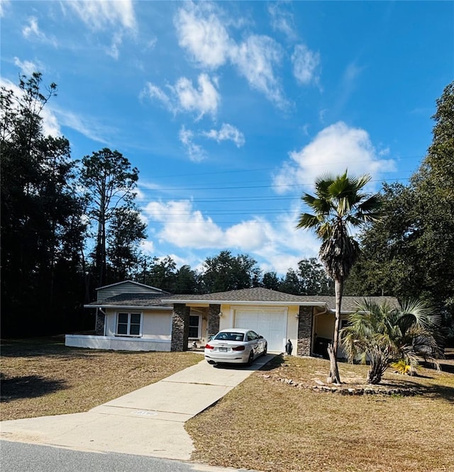 ranch-style home featuring a garage and a front lawn